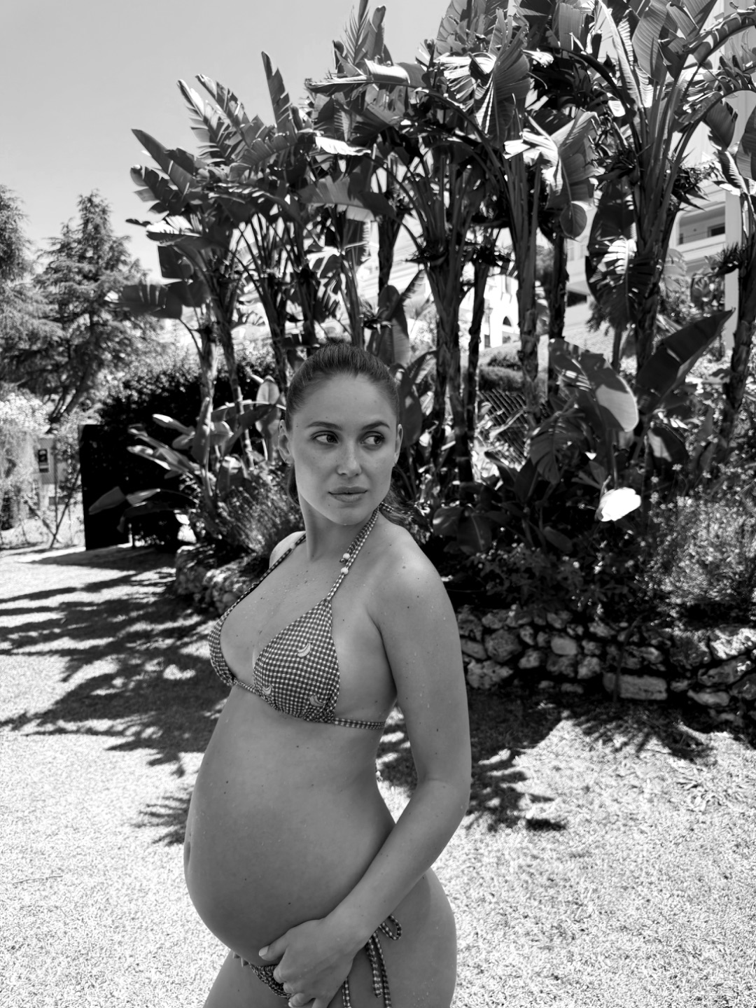 Postpartum woman in a focused Pilates and strength training session, confident and grounded on her mat